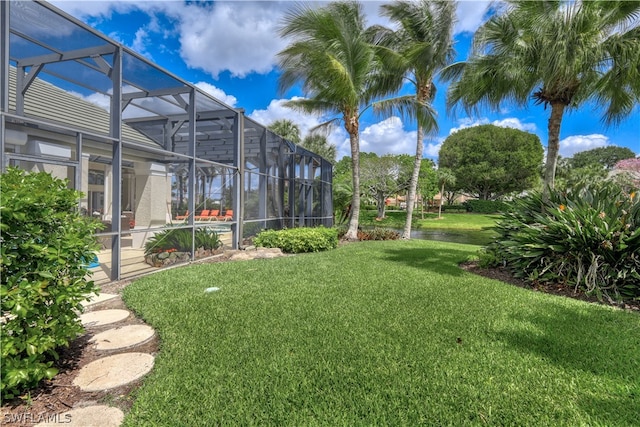 view of yard with glass enclosure