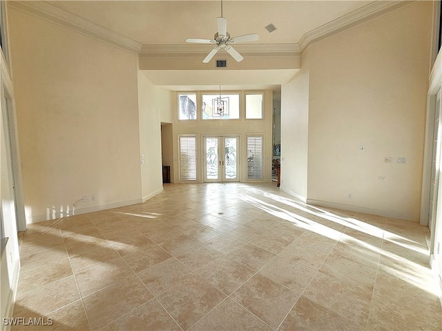 interior space featuring ceiling fan, ornamental molding, a high ceiling, and french doors