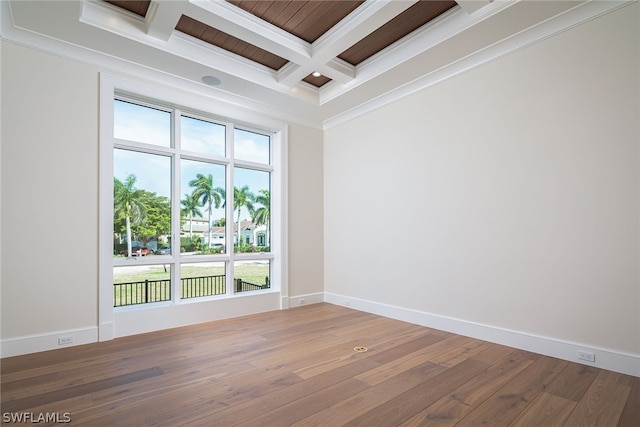 empty room featuring baseboards, coffered ceiling, hardwood / wood-style floors, and ornamental molding