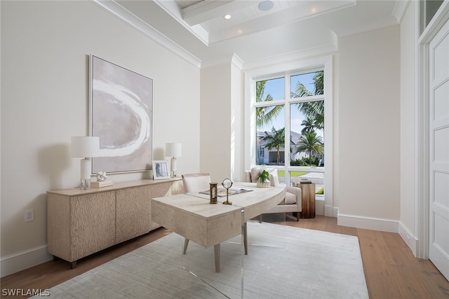 living area with ornamental molding, beamed ceiling, wood finished floors, and baseboards