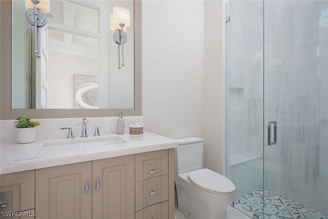 bathroom featuring a stall shower, vanity, and toilet