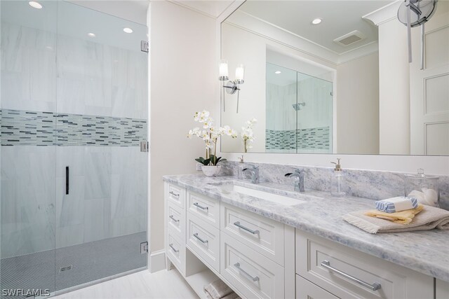 bathroom with visible vents, ornamental molding, vanity, a shower stall, and recessed lighting