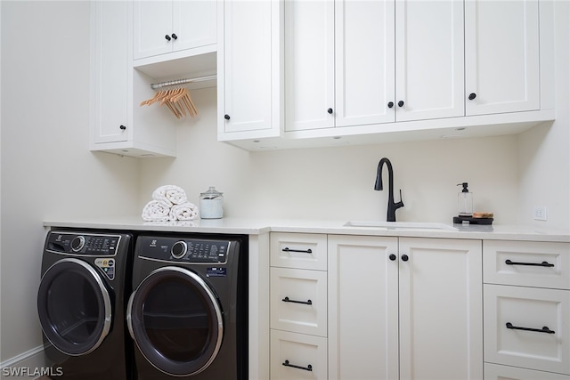 laundry room with washer and clothes dryer, a sink, and cabinet space