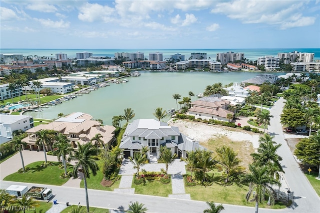 birds eye view of property featuring a water view and a view of city