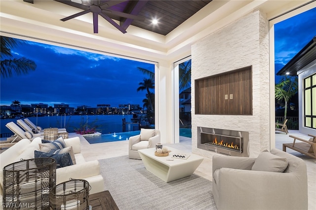 view of patio featuring an outdoor living space with a fireplace and ceiling fan