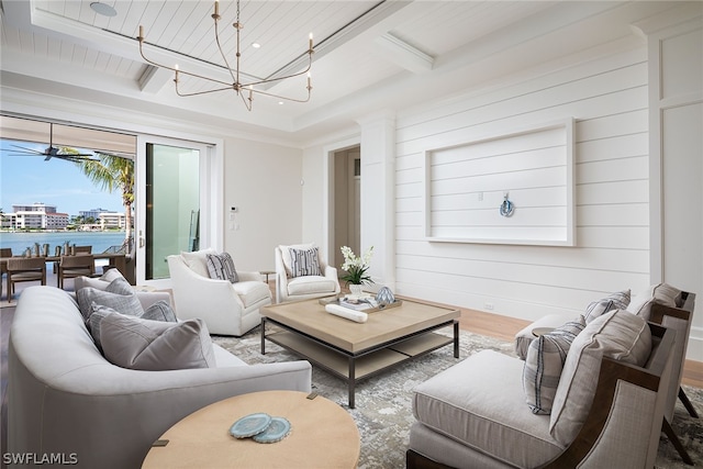 living area with wooden ceiling, a chandelier, beam ceiling, and wood finished floors