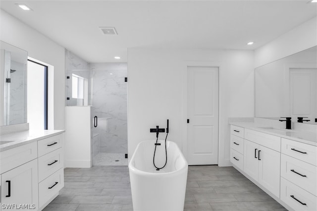 bathroom featuring vanity and shower with separate bathtub