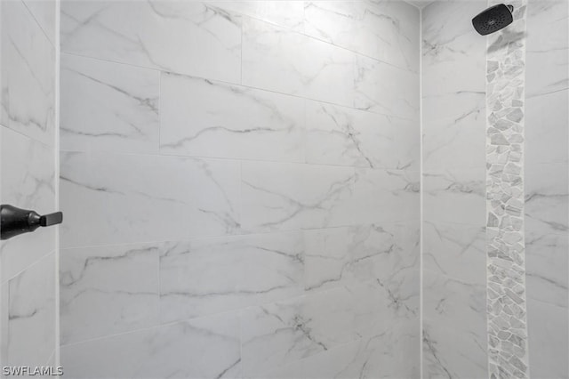 bathroom with a marble finish shower