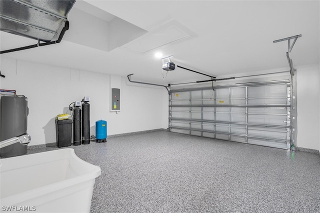 garage featuring a garage door opener, sink, and electric panel