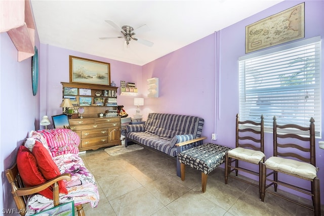 living area featuring ceiling fan and light tile floors