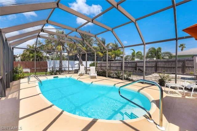 view of swimming pool with glass enclosure and a patio