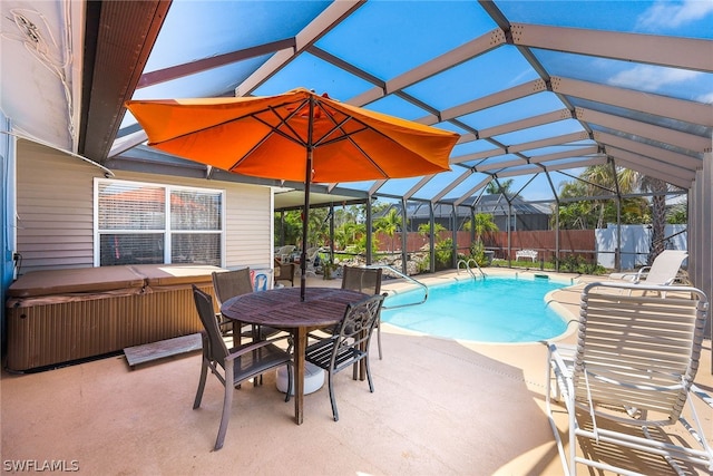 view of pool with a hot tub, a patio, and a lanai