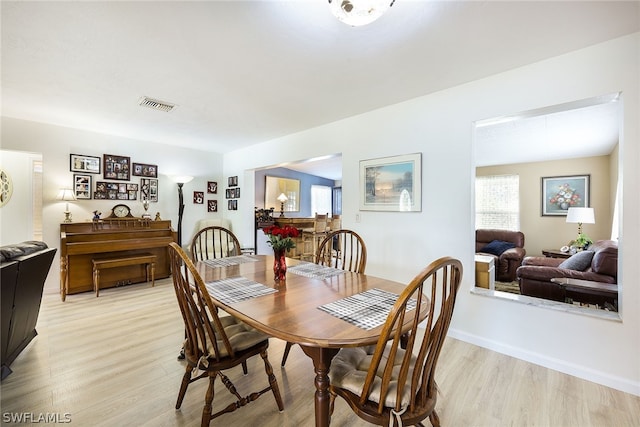 dining space with light hardwood / wood-style floors