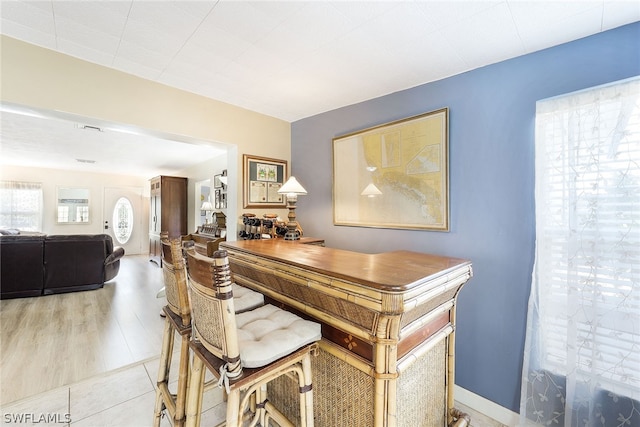 home office with light hardwood / wood-style floors