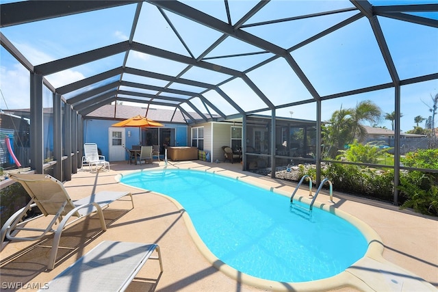 view of swimming pool featuring a patio area and a lanai