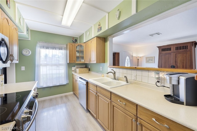 kitchen featuring light hardwood / wood-style flooring, sink, tasteful backsplash, and stainless steel appliances