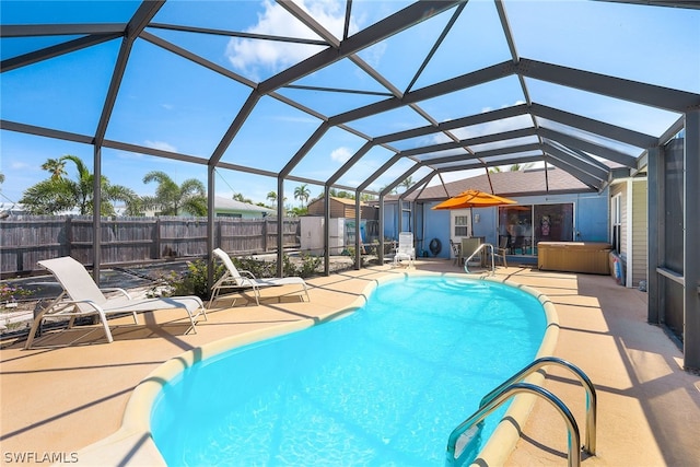 view of swimming pool with a patio, a shed, and glass enclosure