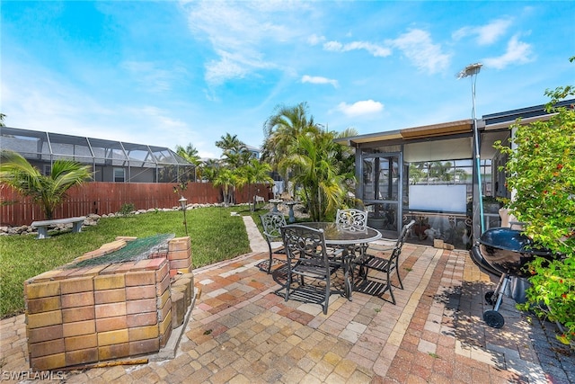 view of patio / terrace featuring a lanai and grilling area