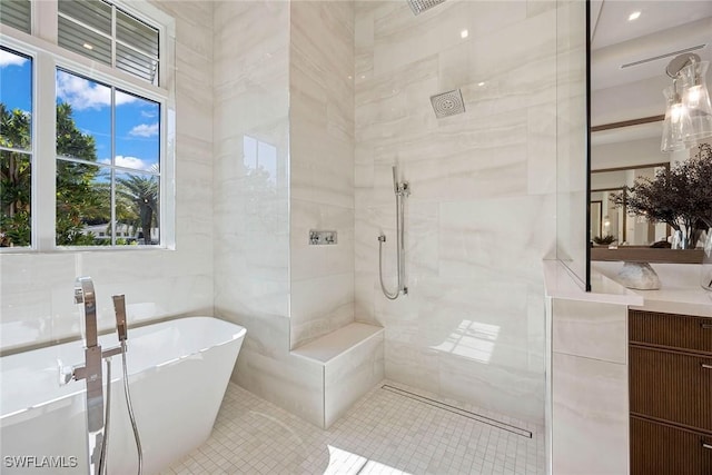 full bath featuring a soaking tub, tile walls, tiled shower, and vanity