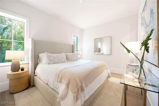 bedroom featuring light wood-type flooring and baseboards