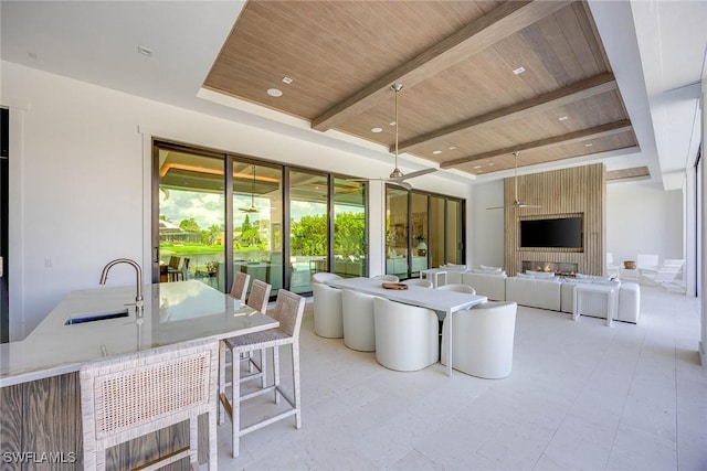 living area with recessed lighting, wooden ceiling, and beam ceiling