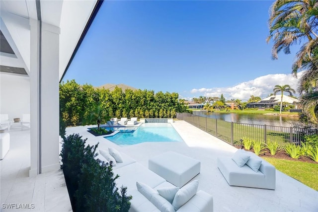 view of pool featuring a patio, a water view, a fenced backyard, and a fenced in pool