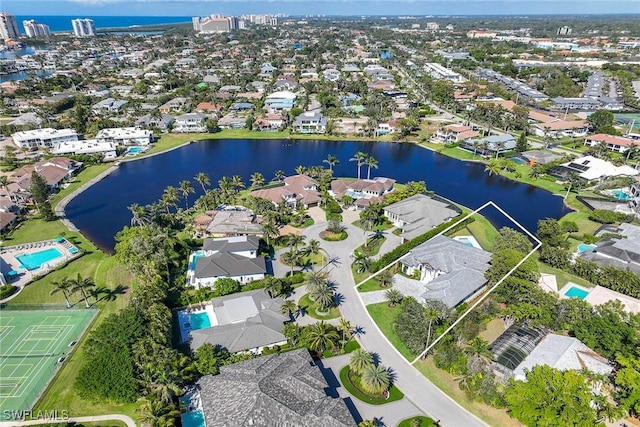 drone / aerial view with a water view and a residential view