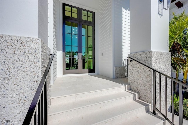 property entrance with french doors and stucco siding