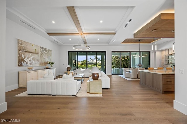 living area featuring beam ceiling, coffered ceiling, light wood-style flooring, and baseboards