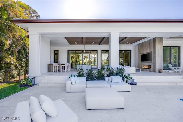 exterior space featuring fence and an outdoor living space with a fireplace