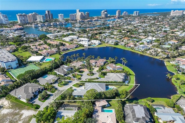 birds eye view of property featuring a residential view, a water view, and a view of city