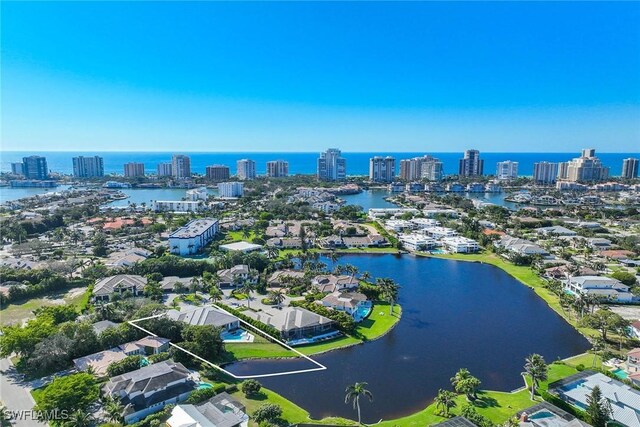 birds eye view of property featuring a view of city and a water view