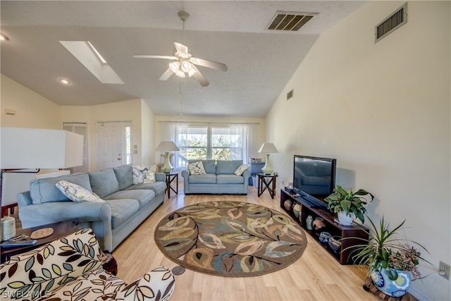 living room featuring high vaulted ceiling, light hardwood / wood-style flooring, and ceiling fan