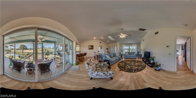 living room featuring vaulted ceiling, ceiling fan, and light hardwood / wood-style flooring