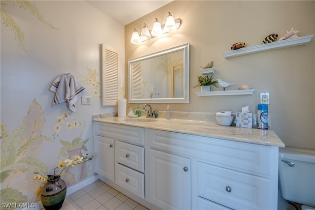 bathroom featuring toilet, tile floors, and vanity