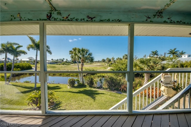 unfurnished sunroom with a water view