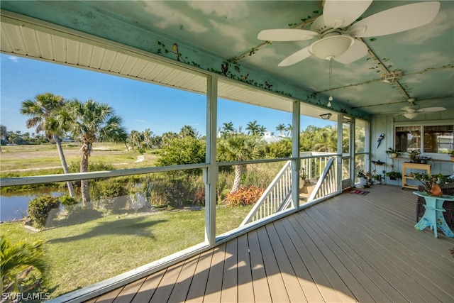 unfurnished sunroom featuring a wealth of natural light and ceiling fan