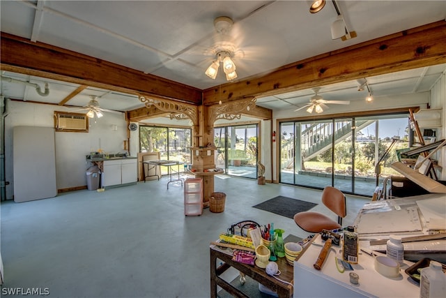 miscellaneous room with ceiling fan, concrete flooring, and a wall mounted AC