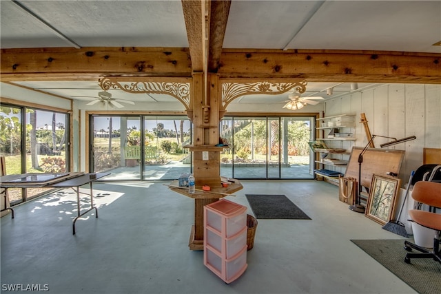 misc room with concrete flooring, beam ceiling, and ceiling fan