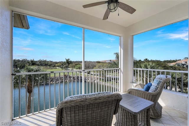 balcony with a water view and ceiling fan