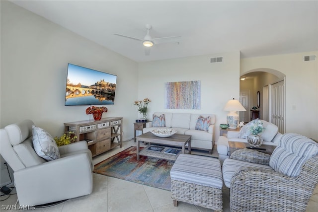 living room featuring light tile flooring and ceiling fan