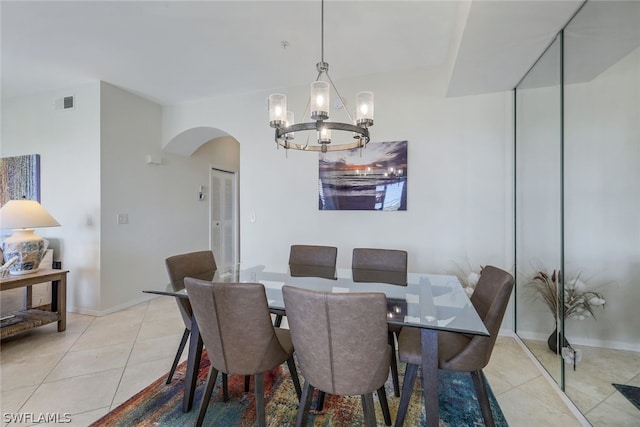 dining room featuring a notable chandelier and light tile floors