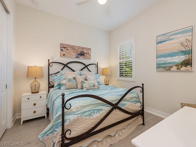 bedroom featuring ceiling fan, light wood-type flooring, and a closet