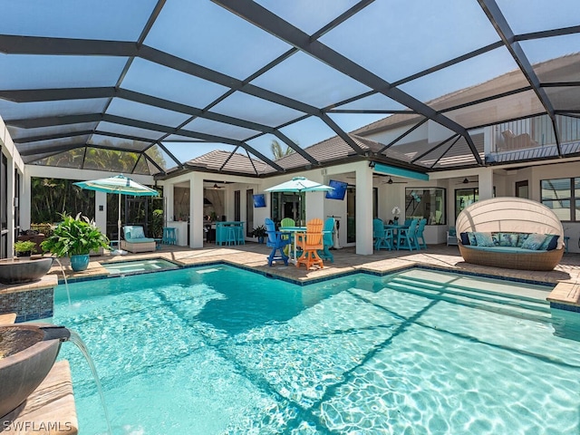 view of pool featuring pool water feature, ceiling fan, a lanai, an in ground hot tub, and a patio area