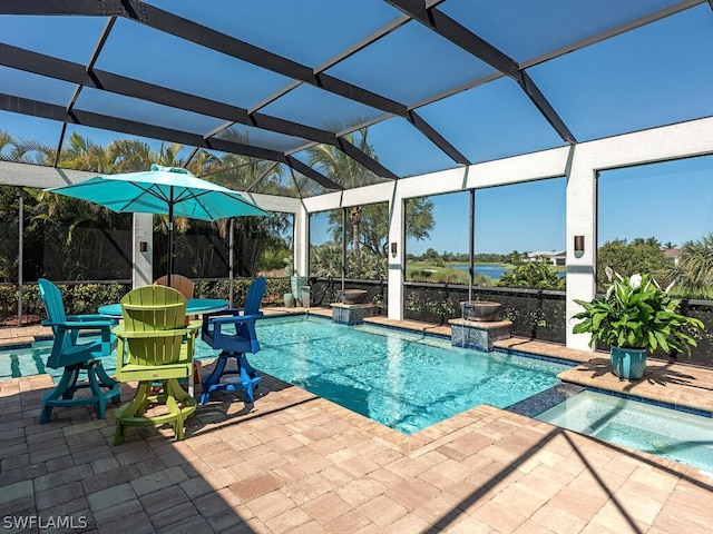 view of pool with glass enclosure, a patio area, and pool water feature