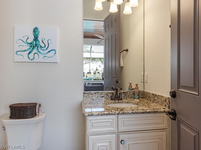 bathroom featuring toilet and vanity