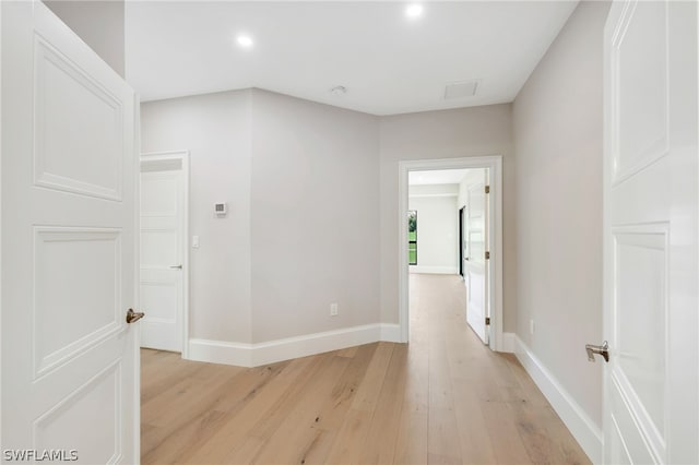 corridor with light hardwood / wood-style flooring