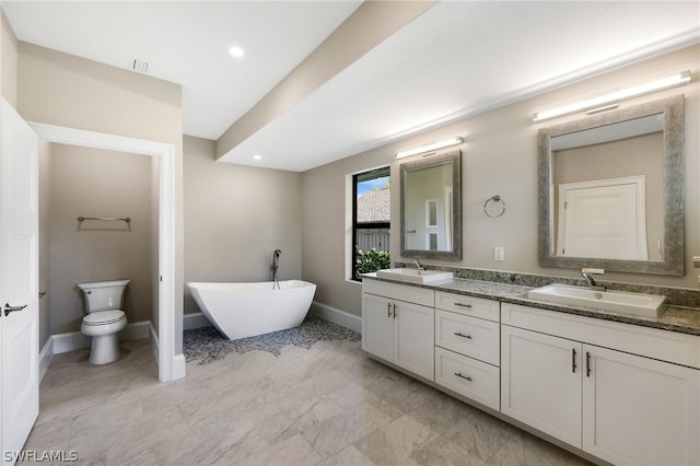 bathroom with vanity, toilet, and a bath