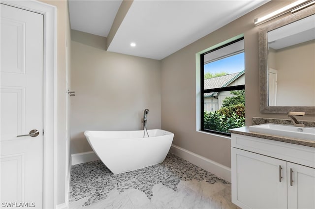 bathroom featuring vanity and a bathing tub