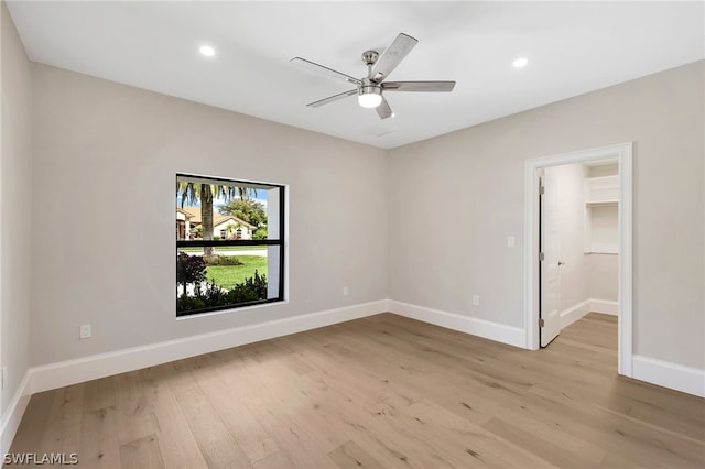 spare room featuring light wood-type flooring and ceiling fan